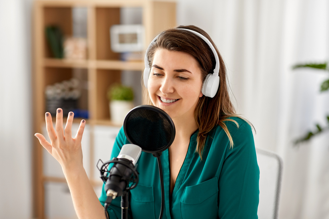 Woman with Microphone Recording Podcast at Studio