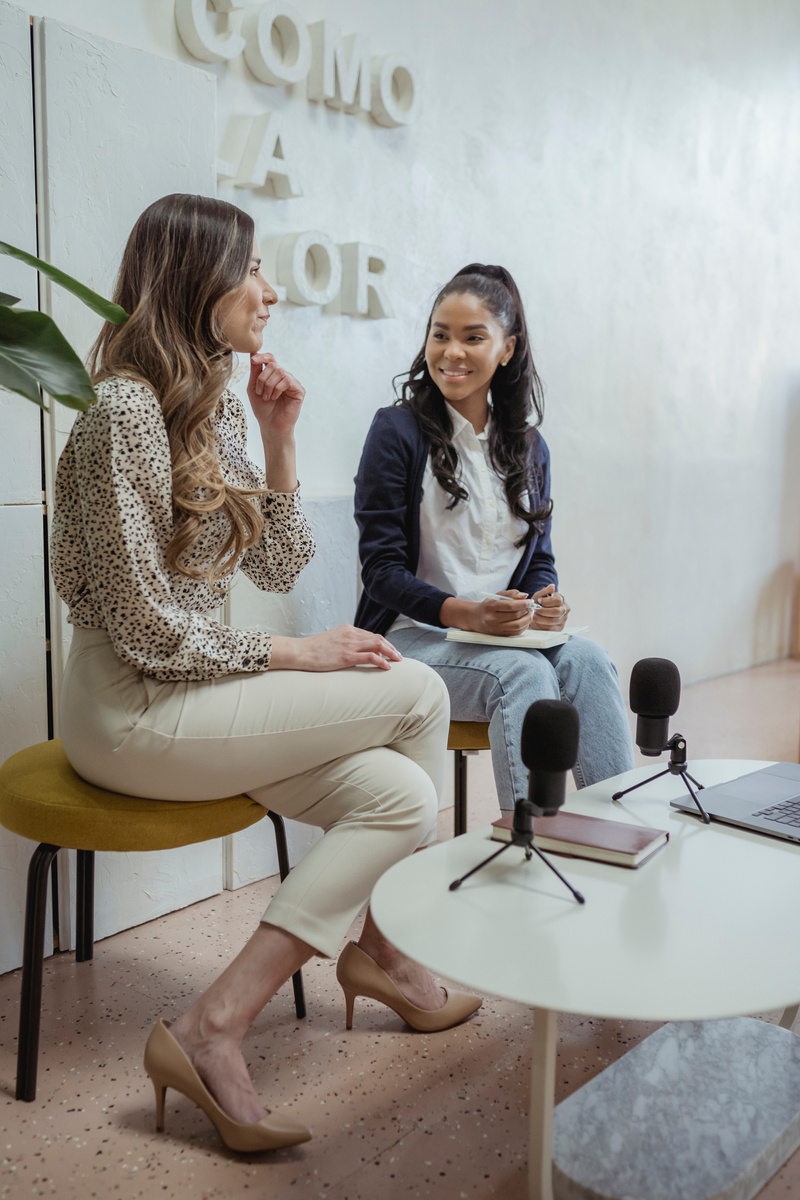 Cheerful diverse women recording podcast